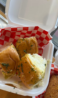 Golden garlic rolls in a red-checkered basket
