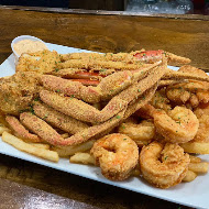 Platter of fried crab legs, shrimp and fries