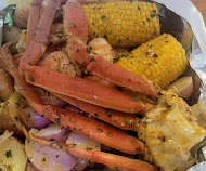 Snow crab legs with corn and potatoes in butter sauce
