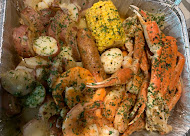 Seafood boil tray with crab, shrimp, corn and potatoes