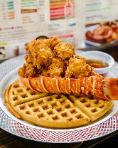 Fried lobster tail over a golden waffle