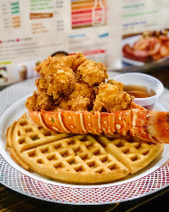 Fried lobster tail on a golden waffle